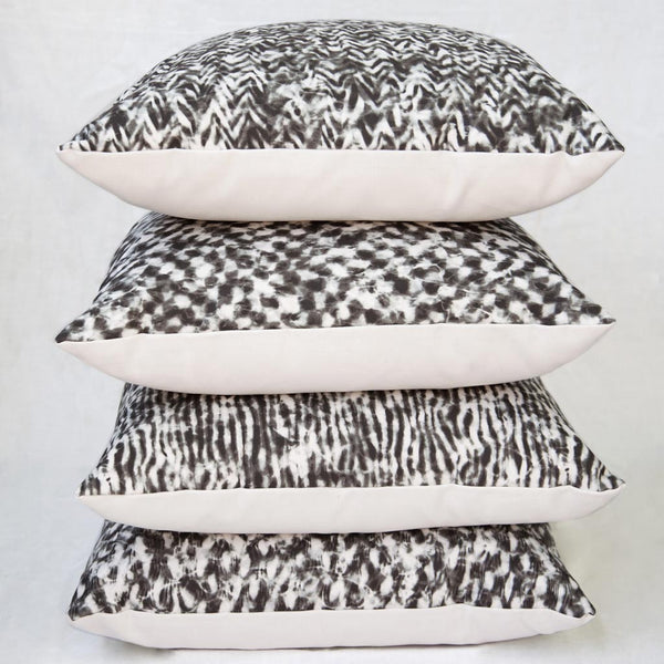 Carley Kahn "Checker" pillow covers. Four of them stacked on top of each other. 