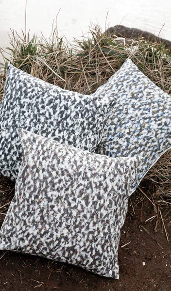 Carley Kahn "Scallop" pillow covers. Three of them on grassy cliff overlooking ocean. 