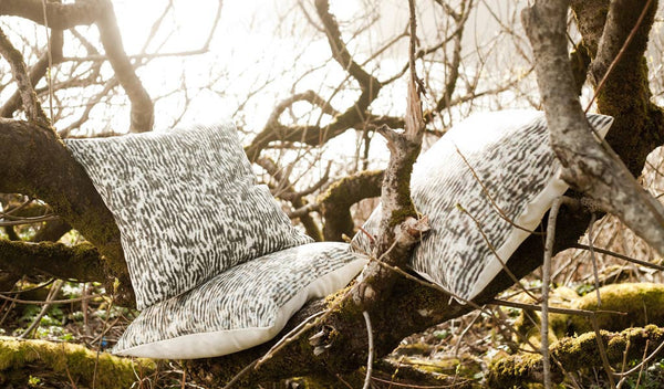 Carley Kahn "Stripe" pillow covers. Three of them arranged in tree, backlit with setting sun. 