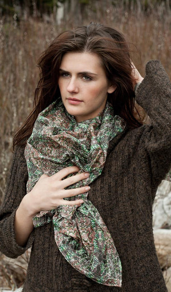 Carley Kahn "Emerald Forest" silk scarf. Model is holding scarf around her neck. 
